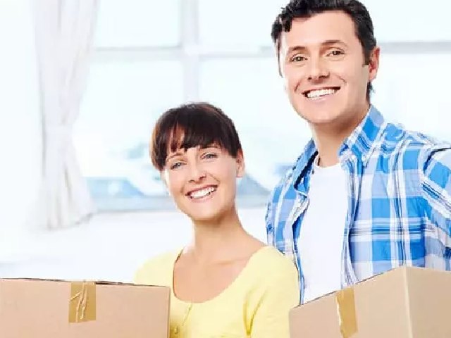 young couple with moving boxes