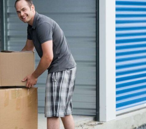 man loading a storage unit with boxes