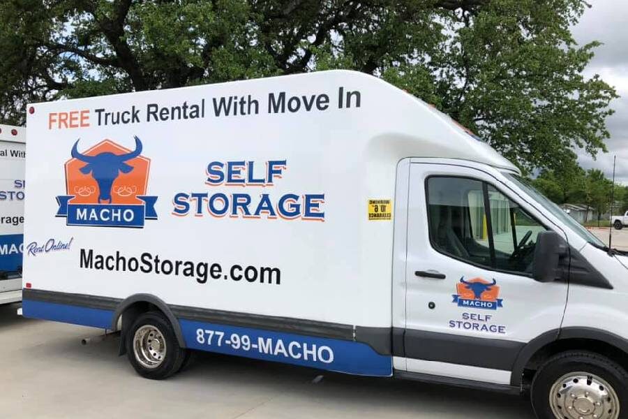 macho self storage truck with free use of moving truck sign on side of van