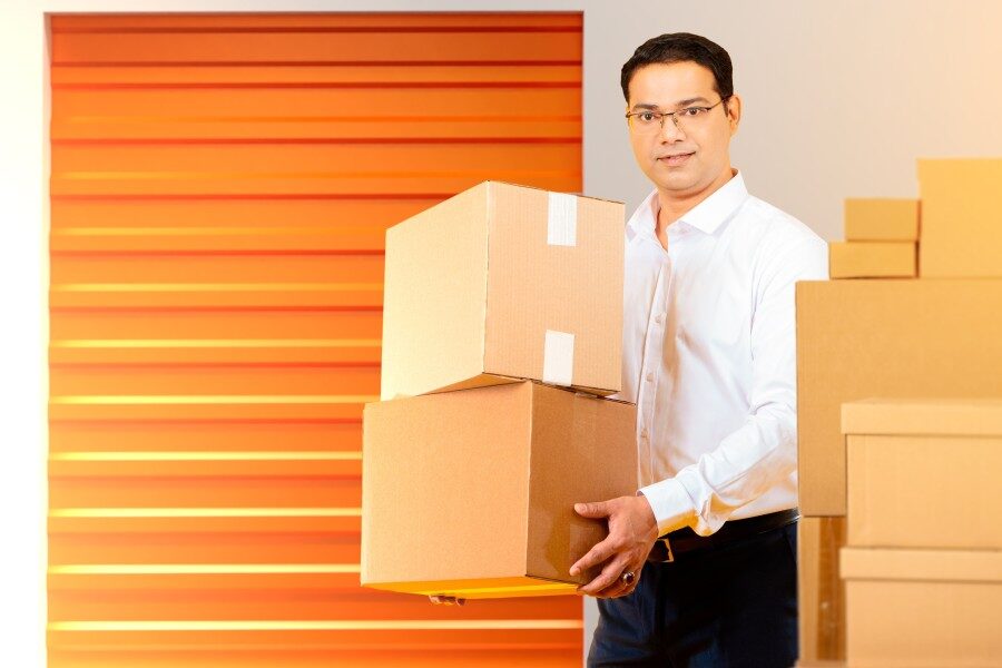 man placing items into storage during the summer